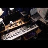 The Studio San Francisco workstation desk with an 88-key MIDI controller, laptop, monitor and nearfield speaker