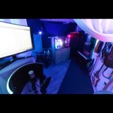 Wide view from the mix position at Studio San Francisco across the live room to the drum kit, upright piano and guitar wall